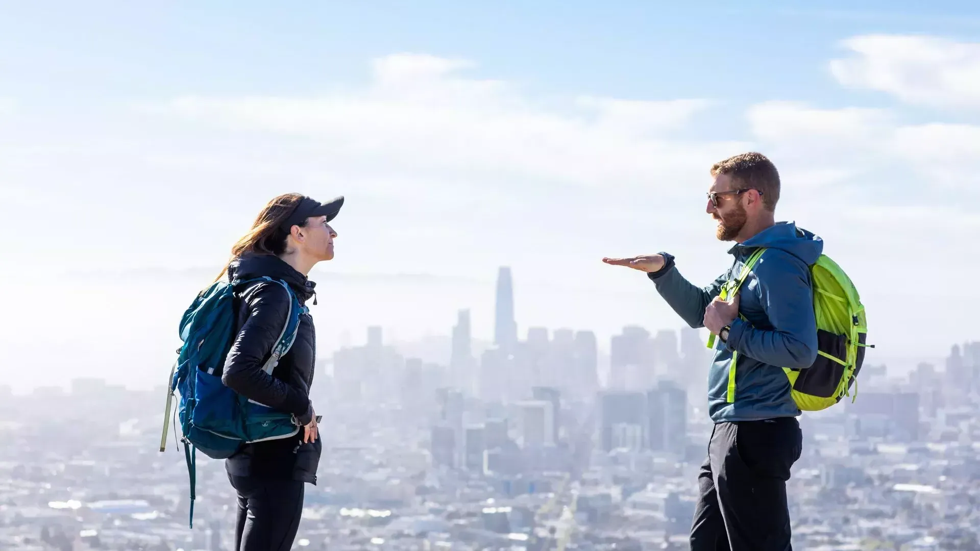 Hikers chatting with the 贝博体彩app skyline in the distance